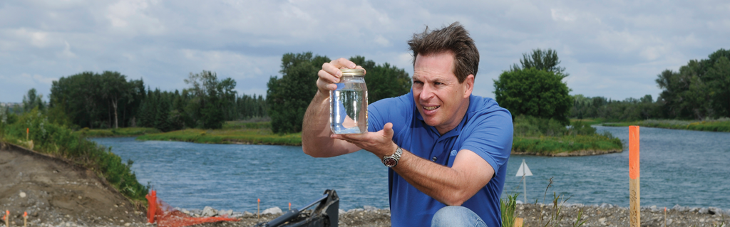 a white man in a blue tee-shirt holds a jar of water. does it contain EDCs?