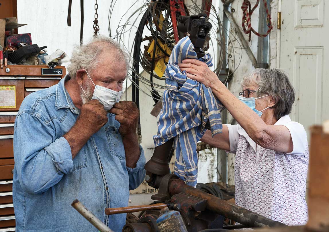 Ron and Joan wearing masks while working.