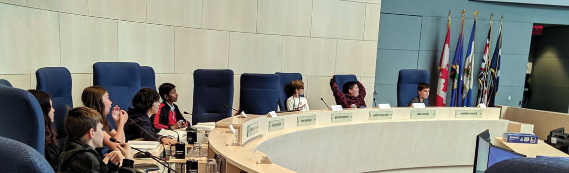 Photo of children sitting in government representative seats