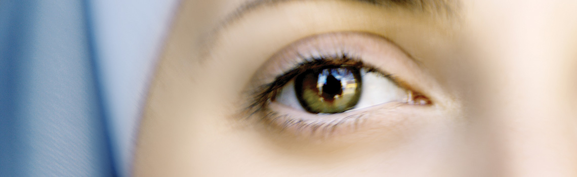 A close up on a person's eye. She is in a blue nun's habit and works at longue pointe