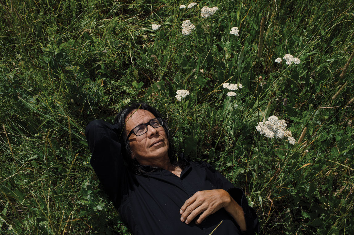 William Singer near some aohtoksooki, or common yarrow.
