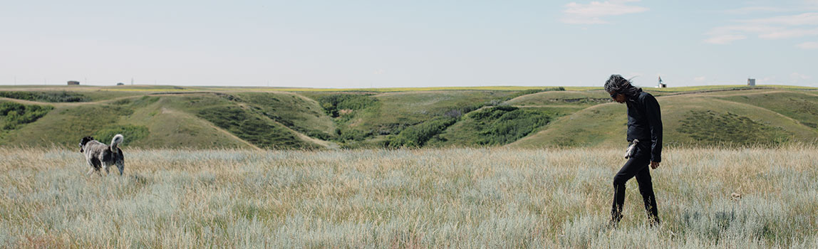 Api’soomaahka, William Singer, with his dog Zorro on the Kainai Blood Tribe reserve near Stand Off.