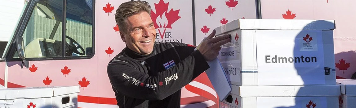 Thomas Lukaszuk stacking boxes of signatures from the forever canadian campaign