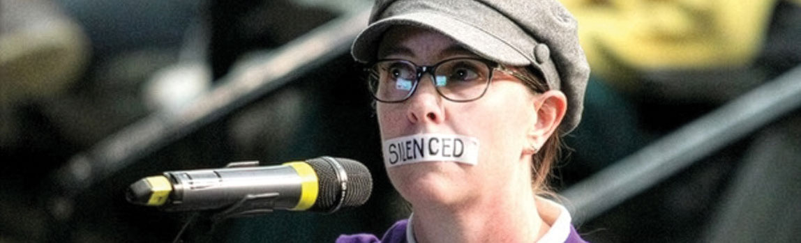Bonnie Larson with tape across her mouth that reads "Silenced" in protest of the closing of supervised consumption sites