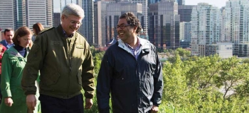 Former Prime Minister Stephen Harper walking with Naheed Nenshi during the 2013 flood